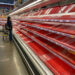 a shopper picks over the few items remaining in the meat section, as people stock up on supplies amid coronavirus fears, at an austin, texas